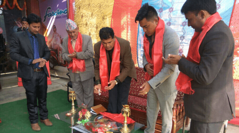 Men in traditional attire participating in a ceremonial lamp lighting ritual during an event.