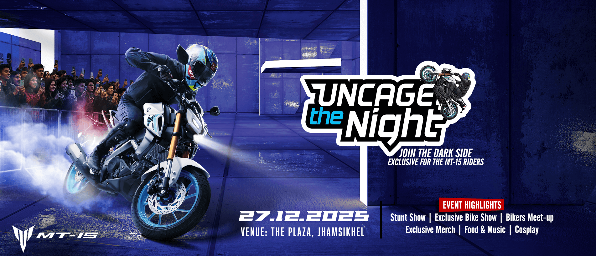 Yamaha MT-15 motorcycle performing a stunt in a blue-themed environment with spectators in the background.